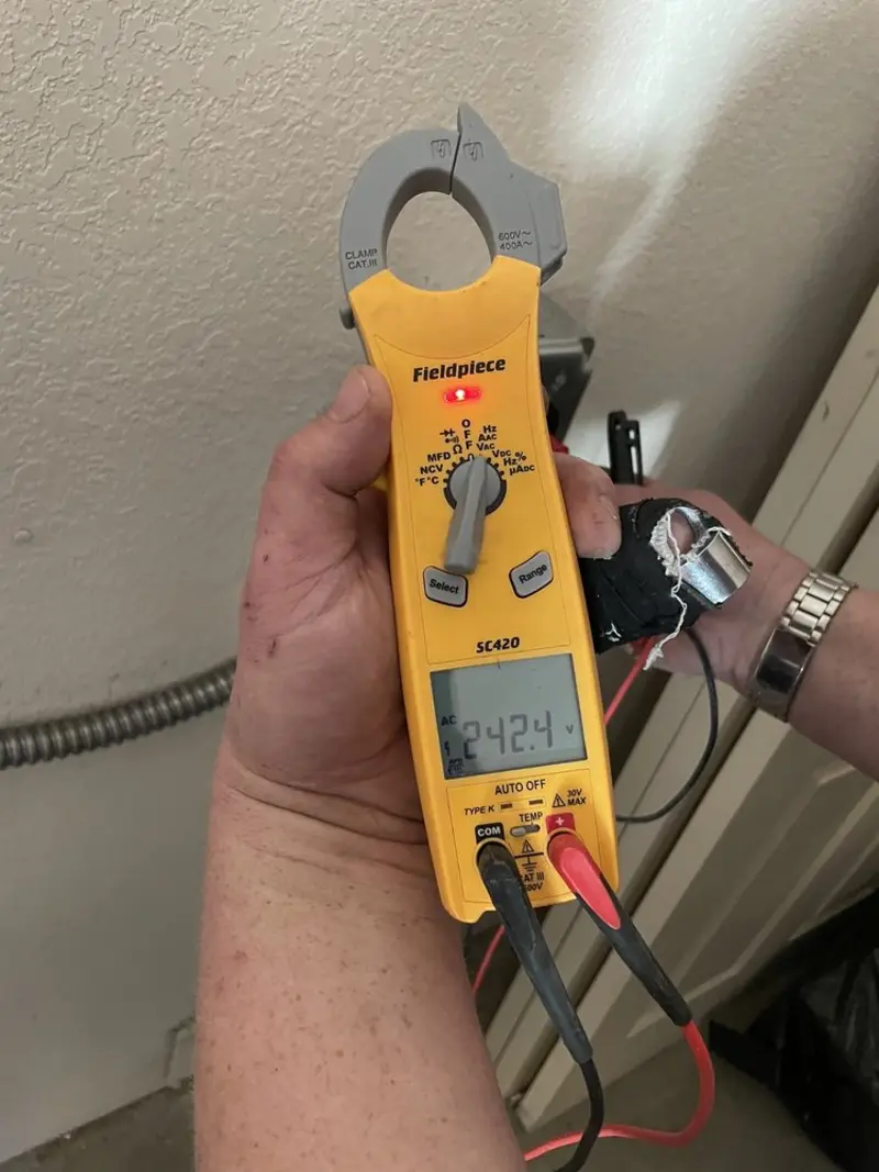 Voltage testing with clamp meter during Ceiling Fan Installation in Bastrop